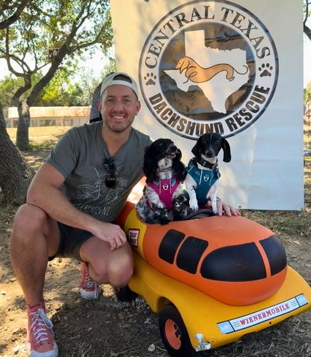 Andrew, Zelda (long-hair dapple dachshund) and Linc (short-hair piebald dachshund) in Wienermobile at Buda Lions Club wiener dog race sponsored by Central Texas Dachshund Rescue