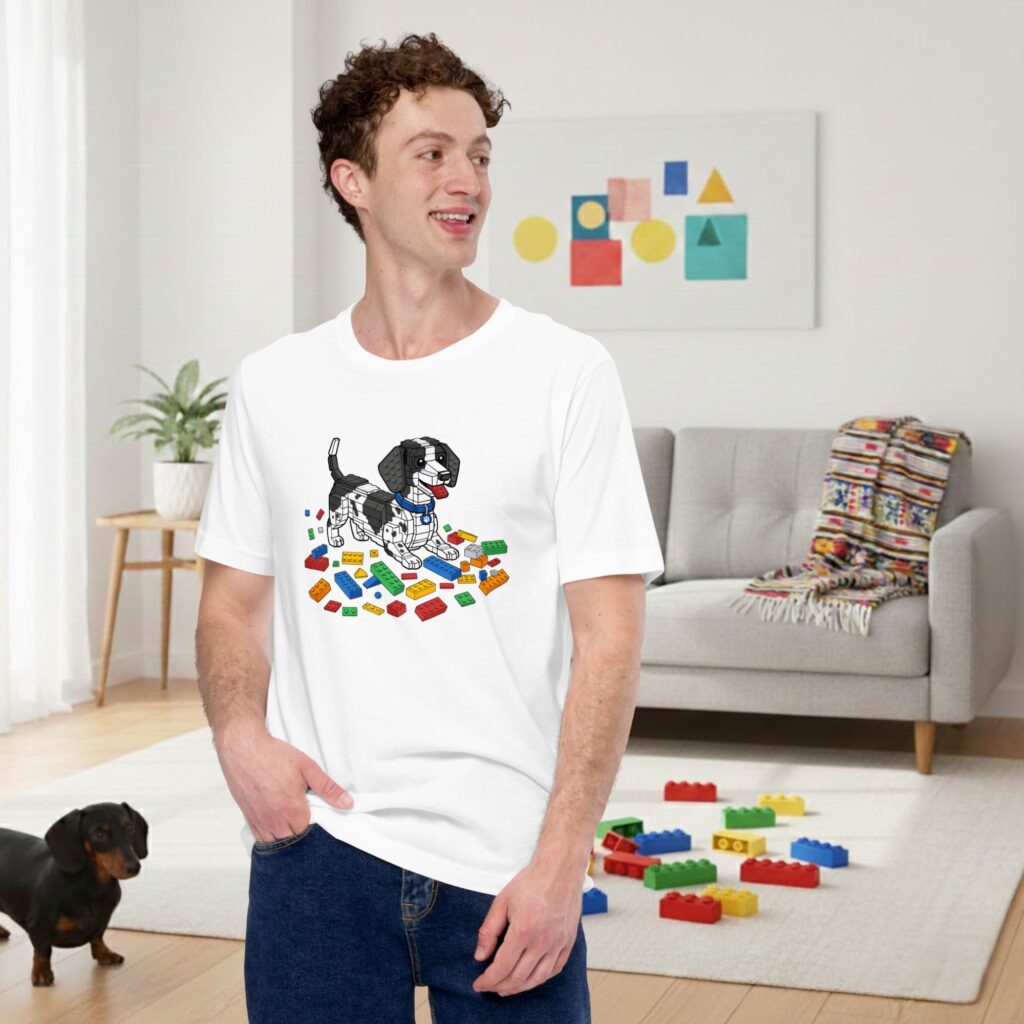 Man wearing a white dachshund building block t-shirt, standing against a neutral background.