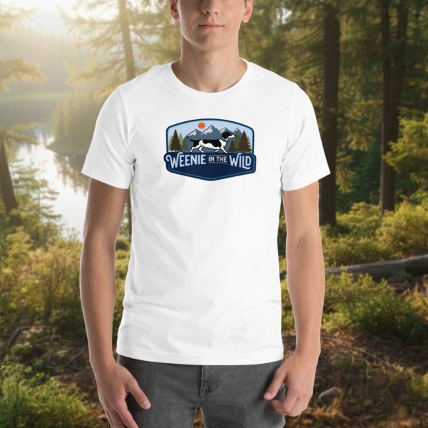 Front view of a man wearing the white Weenie in the Wild hiking tee, demonstrating the retail fit and minimalist mountain dachshund design.