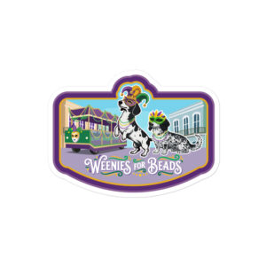 A kiss-cut vinyl sticker featuring two dachshunds wearing Mardi Gras beads with "Weenies for Beads" text in purple, green, and gold.