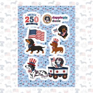 A high-quality product shot of the America 250 Patriotic Dachshund Kiss-Cut Sticker Sheet. The sheet features a light blue repeating pattern background adorned with multiple individual kiss-cut stickers, including a commemorative "AMERICA 250" logo badge, a "dapplepie doxie" circular brand seal, and several illustrated dachshunds dressed in red, white, and blue holiday gear. The image is framed by a faded border of the same pattern.