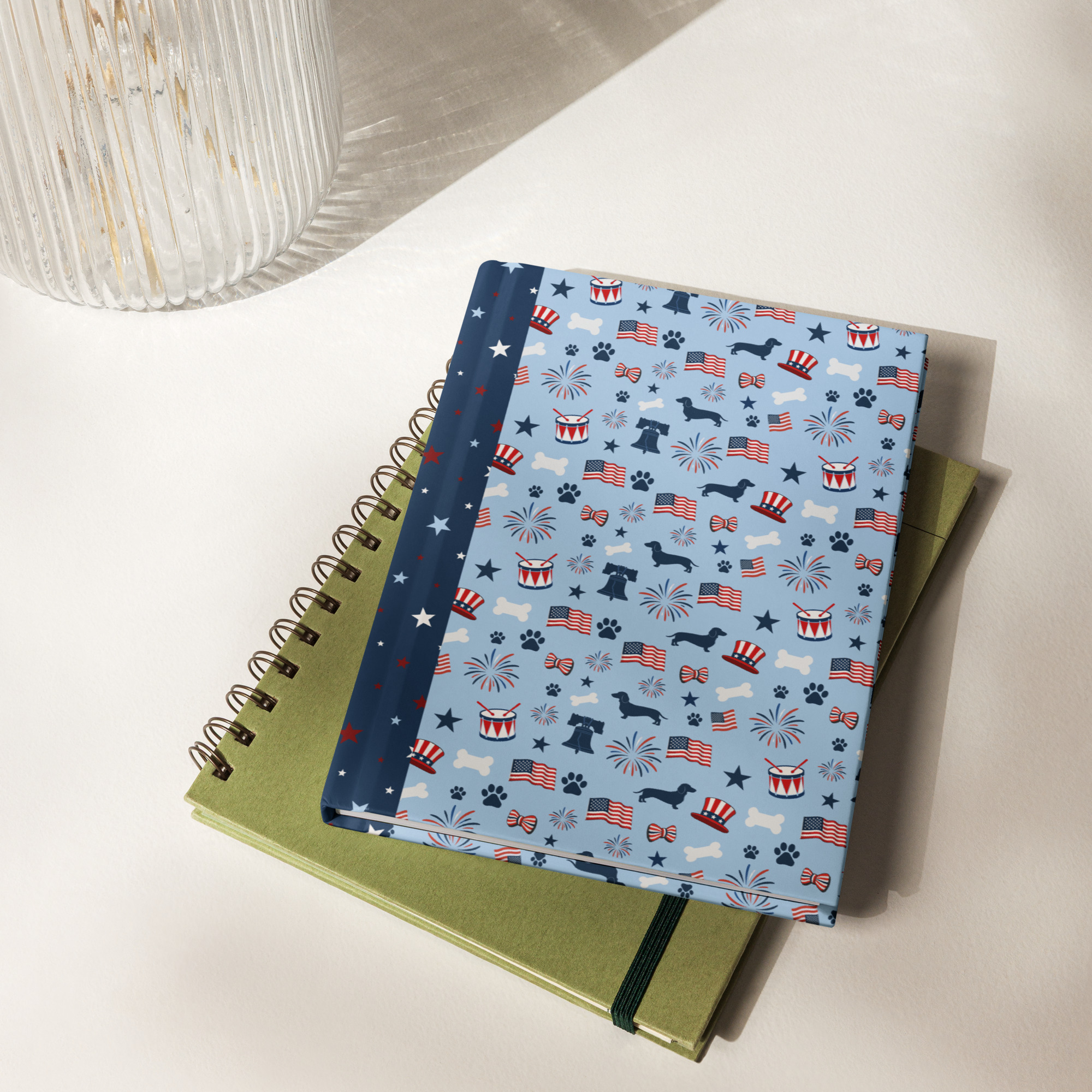 Full front cover view of the hardcover journal with its distinctive casewrap binding, displaying a centered vertical graphic of a black and white dachshund wearing an Uncle Sam top hat with stars and red-and-white stripes.